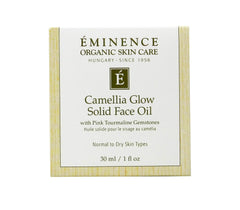 Eminence Camellia Glow solid face oil melting in palm for quick hydration.