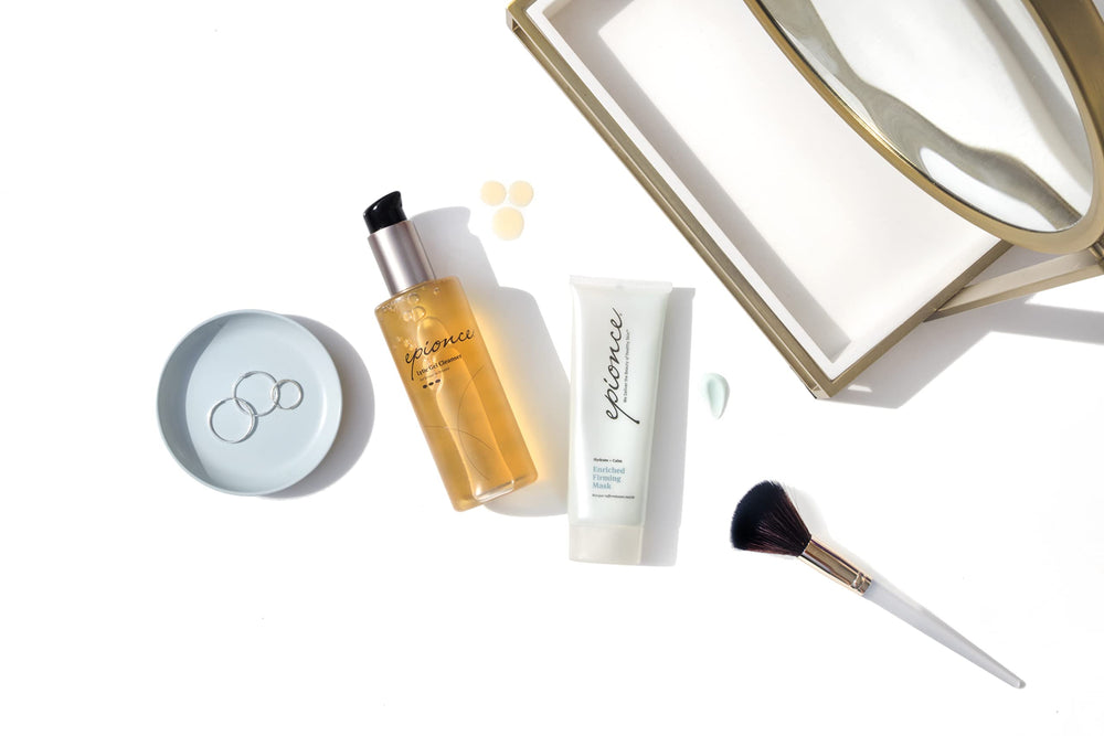 Epionce Enriched Firming Mask on a model’s cheek after application.