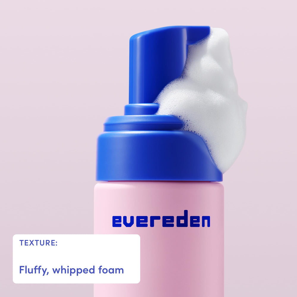Evereden bottle being held shows easy daily application during bath time.