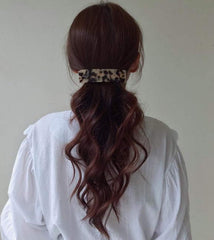 Eyegla celluloid rectangle barrette side twist highlights versatile styling options.