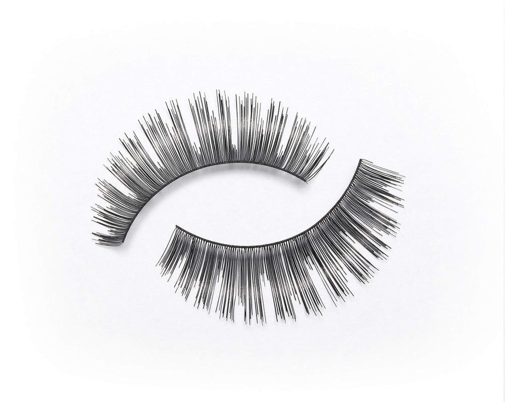 Eylure Volume No.101 lashes in hand for easy measurement and trimming.