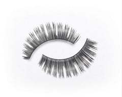 Eylure Volume No.101 lashes in hand for easy measurement and trimming.