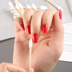 Fcozpjk cotton swabs in use as makeup applicators for eyeliner and lip color.