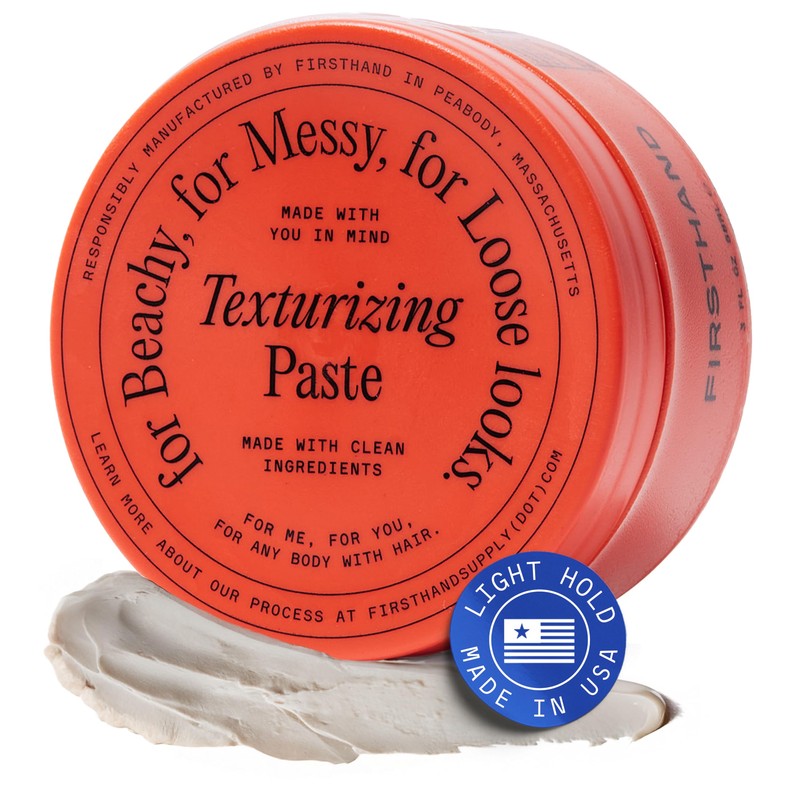 Firsthand texturizing paste bottle closeup for natural waves and volume