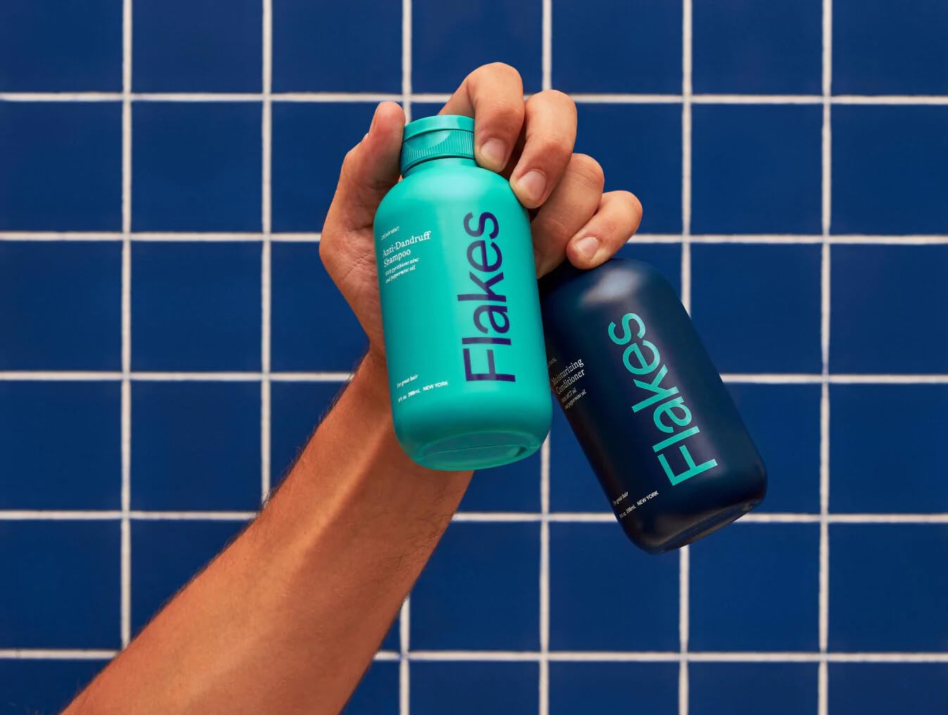 Flakes duo on bathroom shelf suggesting calming at-home scalp care routine.