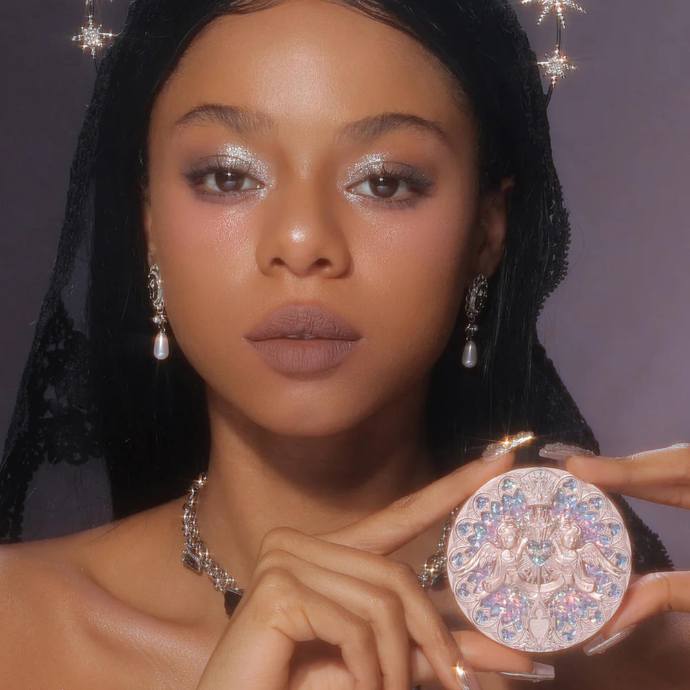 Flower Knows Little Angel rosy-pearl shade swatch reveals soft pink luminosity on cheeks and collarbone.