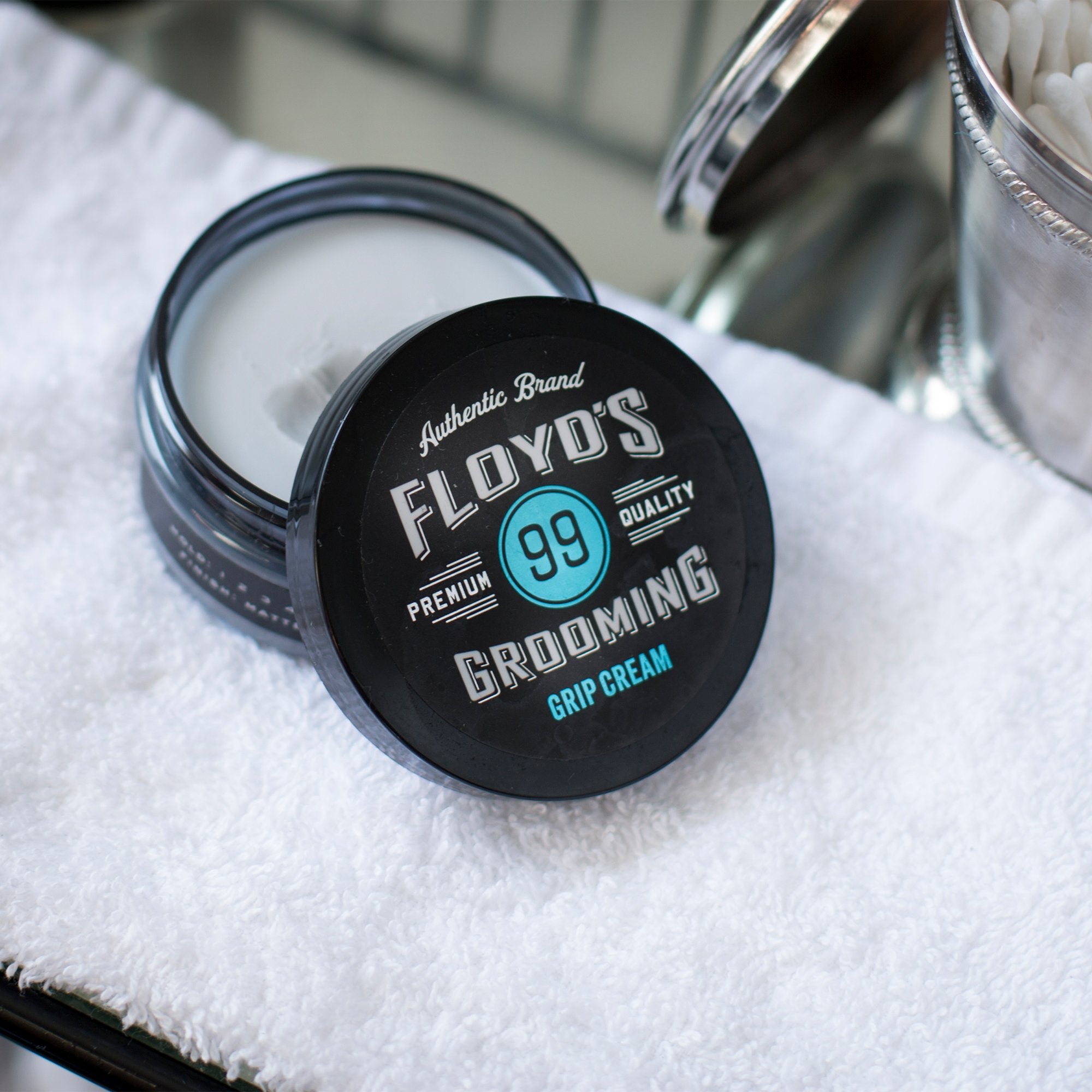 Floyd's 99 Grip Cream applied to hair shows even distribution and texture