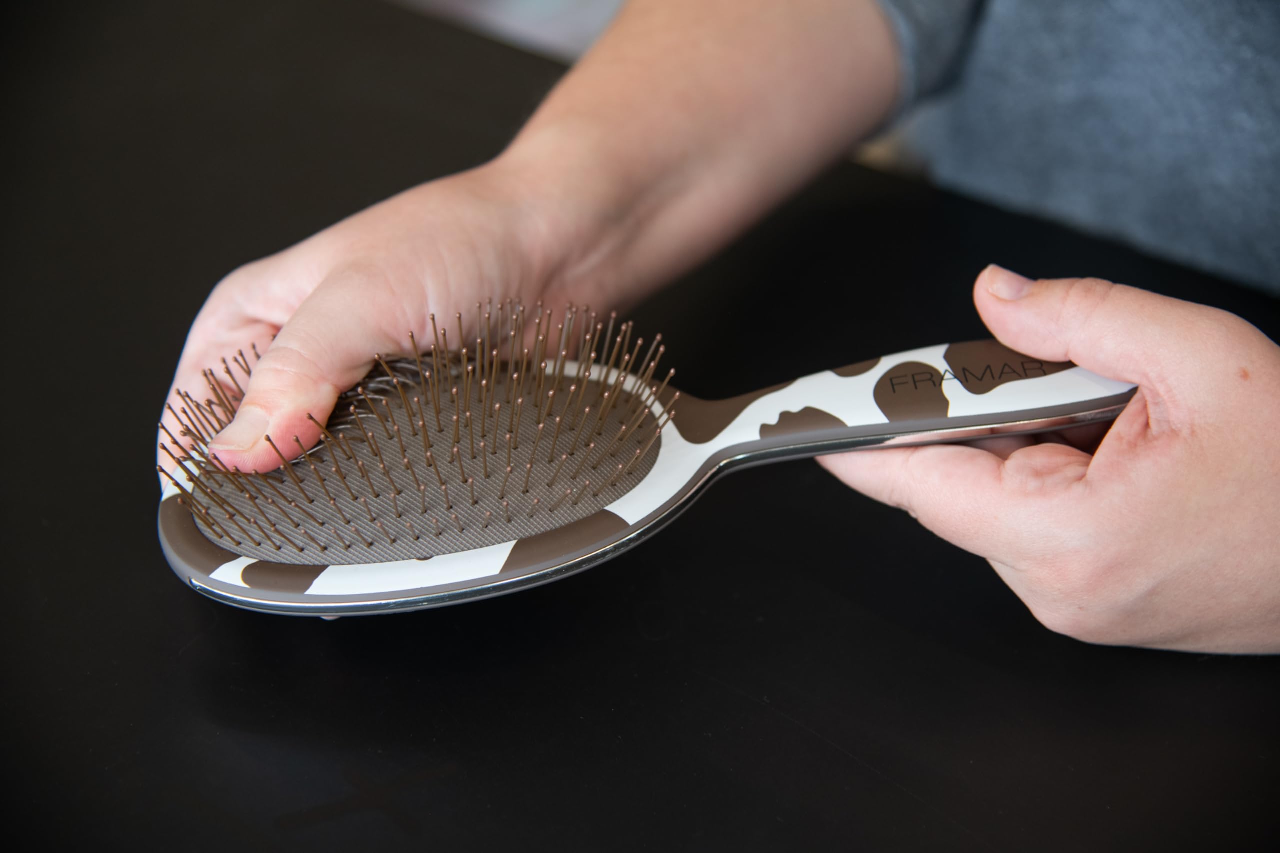 FRAMAR cow-print hair brush with ergonomic handle for secure brushing