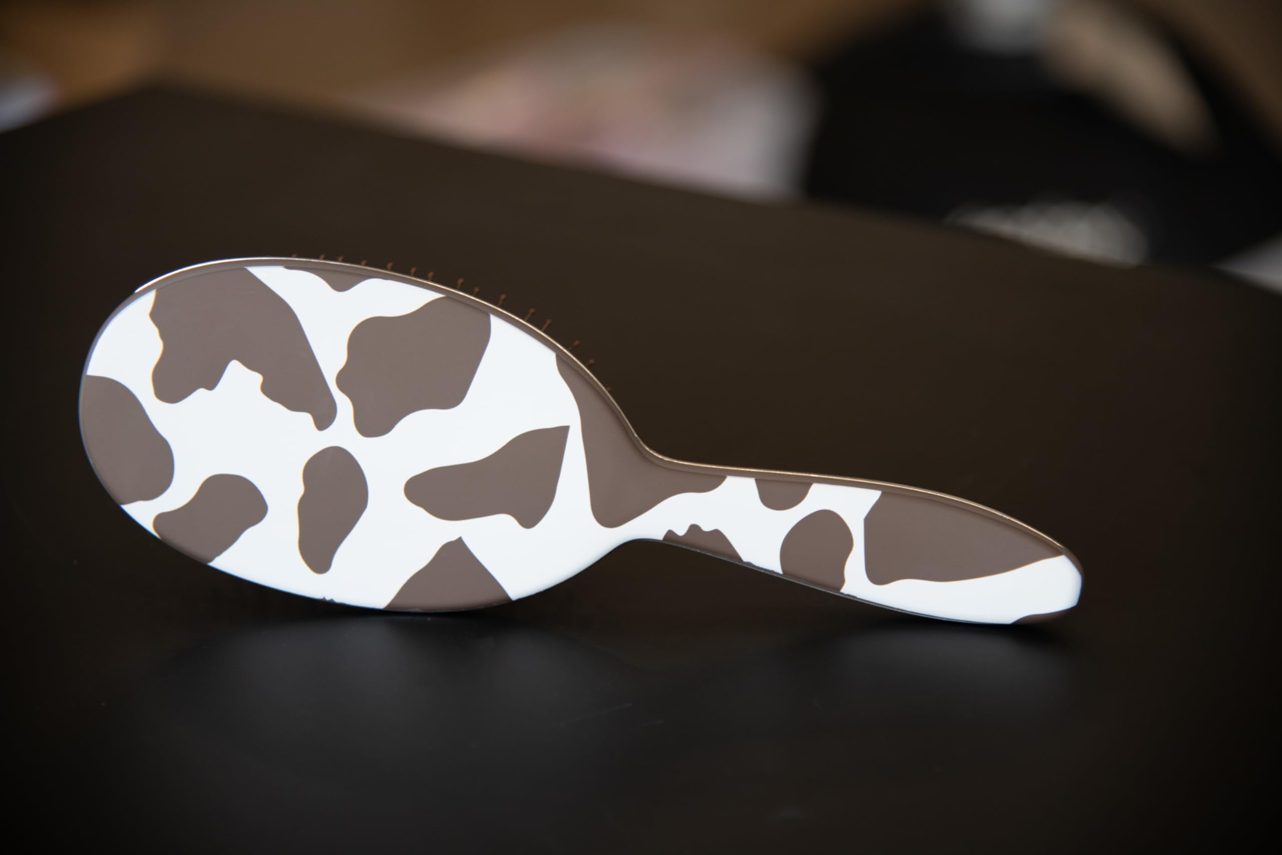 FRAMAR cow-print hair brush compact design fits in purse for on-the-go styling
