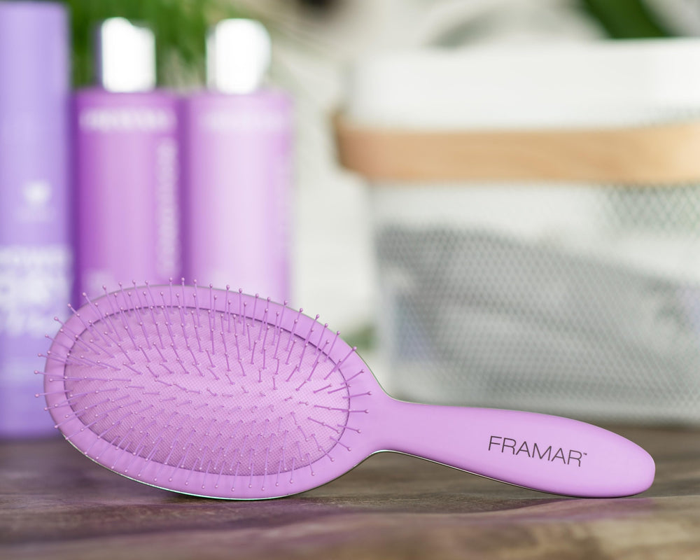 FRAMAR Detangling Brush with ergonomic handle for secure brushing.