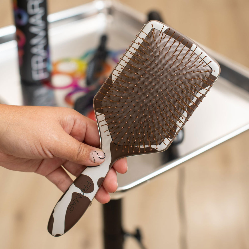 FRAMAR soft-bristle brush glides through hair, gentle on sensitive scalps