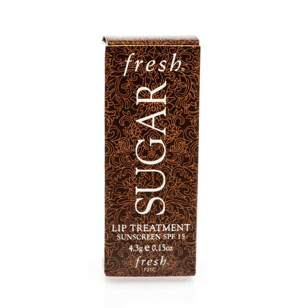 Fresh Sugar Lip Treatment SPF 15 packaging close-up highlighting citrus scent and lip care.