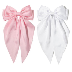 Furling Pompoms pink hair bow clip for women, adds elegant flair.