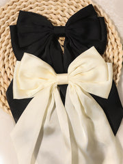 Furling Pompoms satin bow closeup shows rich texture and premium finish.