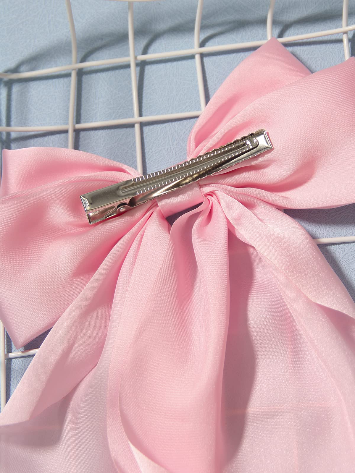 Furling Pompoms satin bow detail adds chic touch to hairstyles
