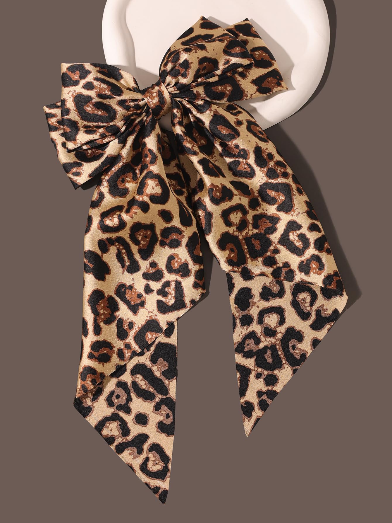 Furling Pompoms secure clip camel-wearing bow ensures all-day hold.