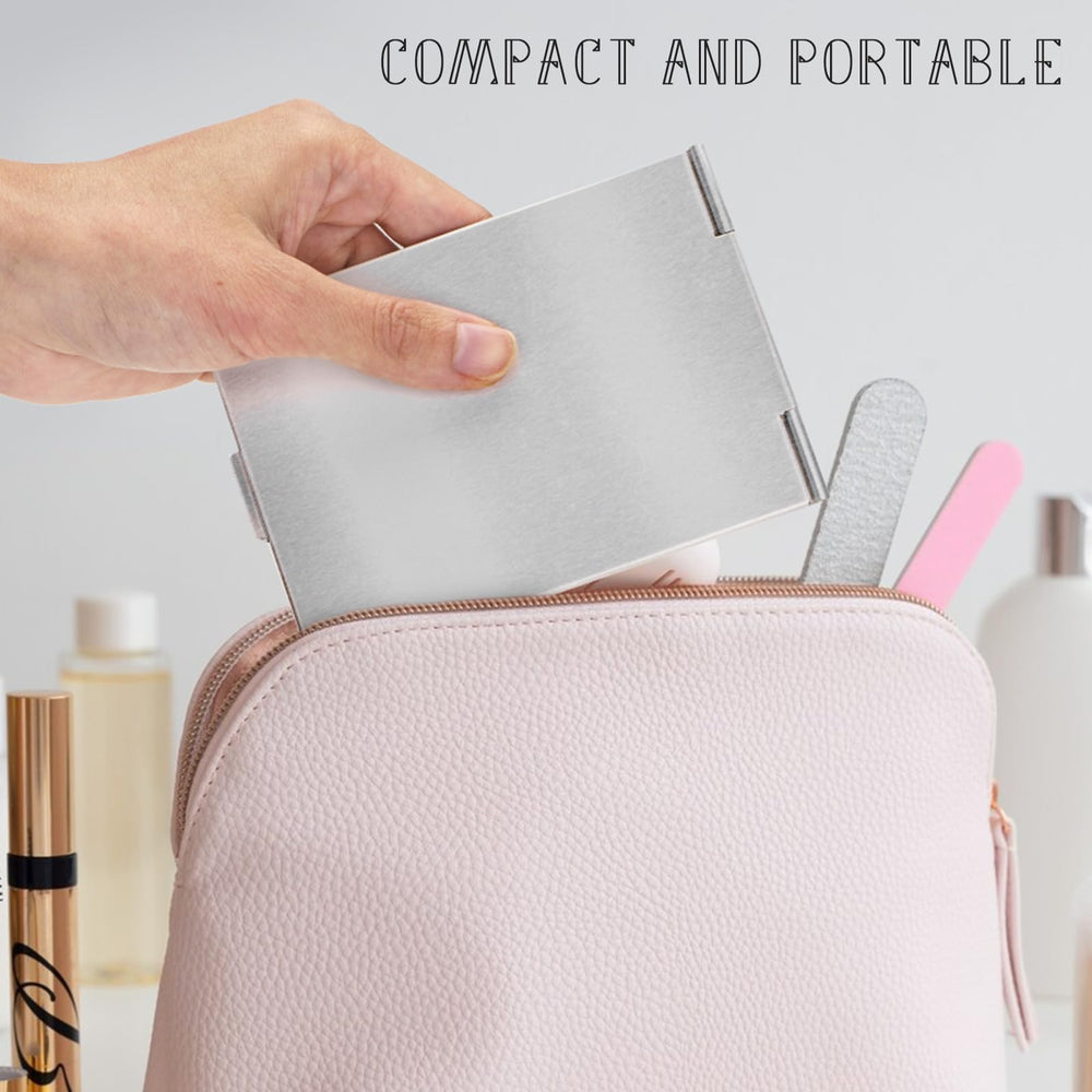 G2PLUS compact travel mirror held in hand showing portability