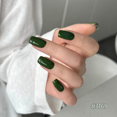 GAOY Emerald gel polish bottle closeup adds gemstone vibe to nails.