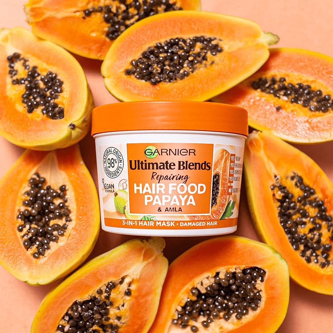Garnier Hair Food Papaya 3-in-1 papaya slices highlight natural extracts for shine.