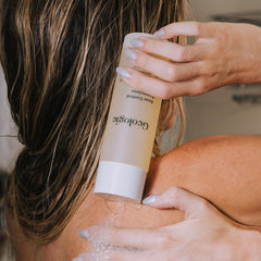Geologie Acne Control Body Wash lather closeup highlights 2% salicylic acid exfoliation.