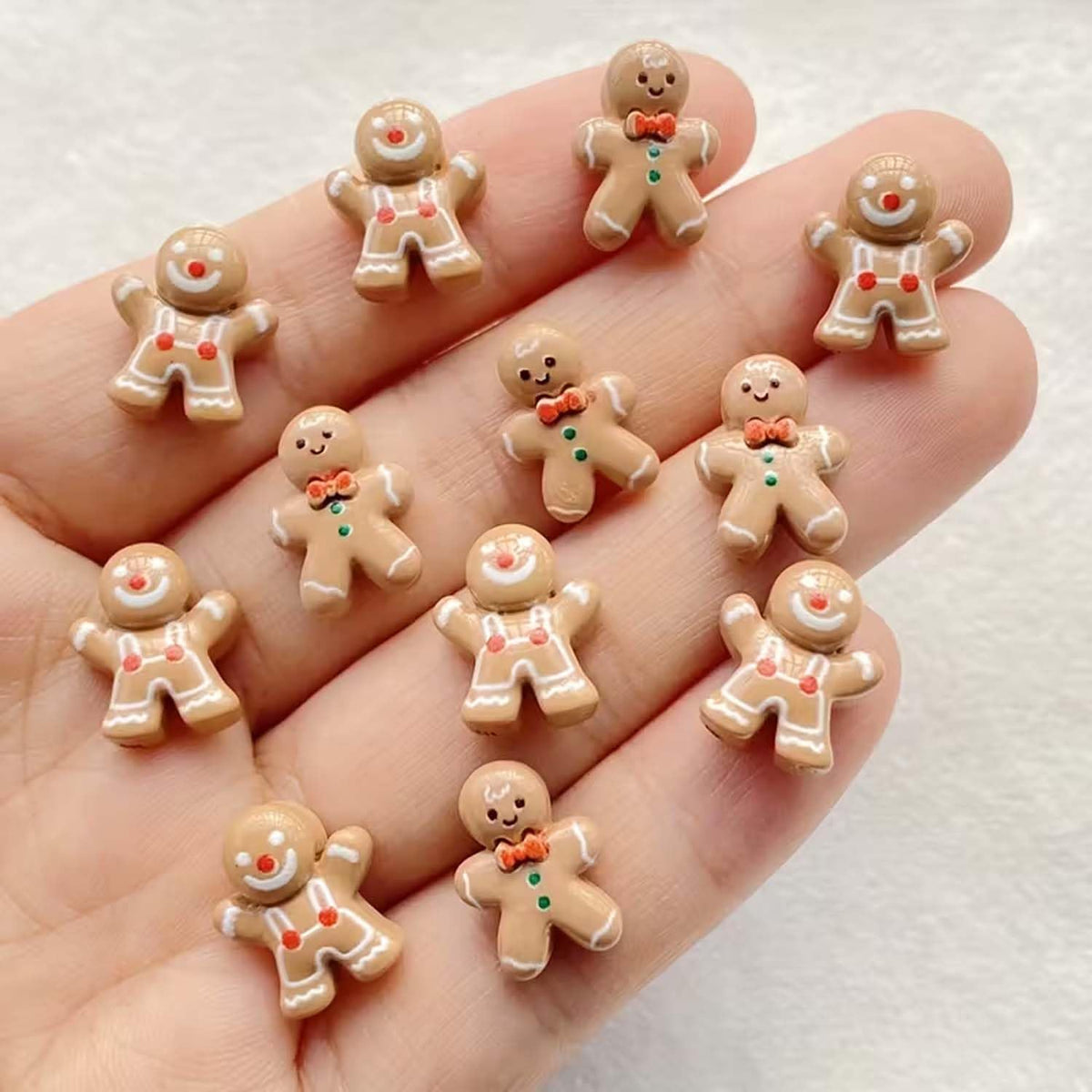 Gingerbread-man nail charms light coffee close-up highlighting festive detail