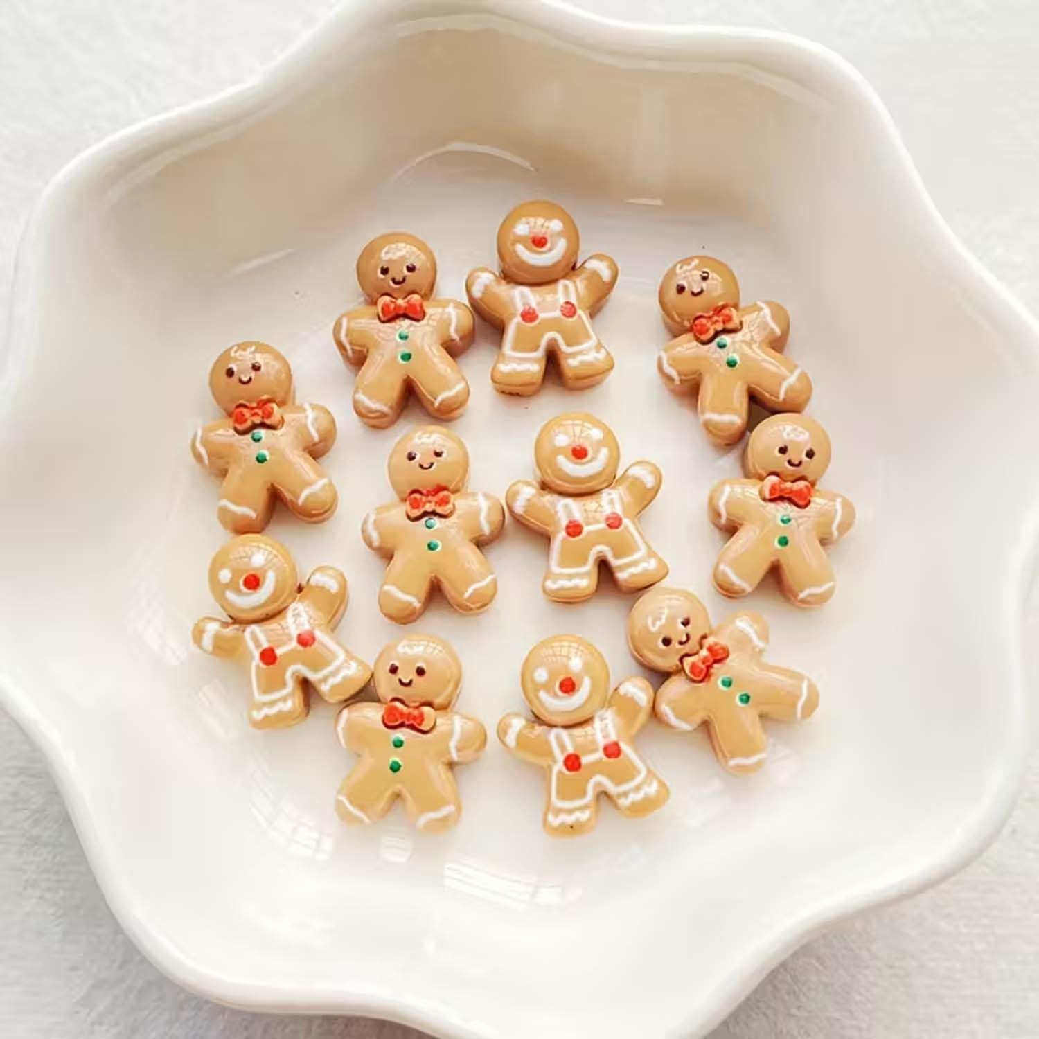 Gingerbread-man nail charms on nails for quick festive DIY manicure