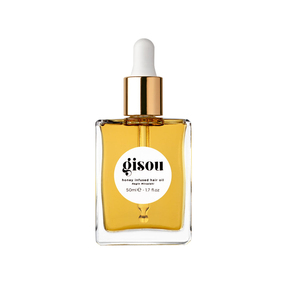 Gisou Honey Infused Hair Oil bottle pour demonstrates hydrating luxury for frizz control.