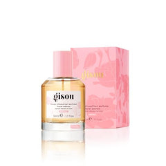 Gisou Honey Infused Hair Perfume Wild Rose application shows an effortless fragrance spritz.