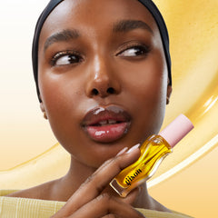 Close-up of Gisou Honey Infused Lip Oil droplets emphasizing nourishing formula.