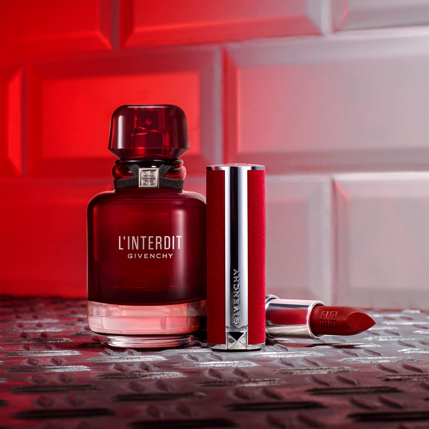 Givenchy L’Interdit Rouge bottle in mirror reflects luxury and versatile style.