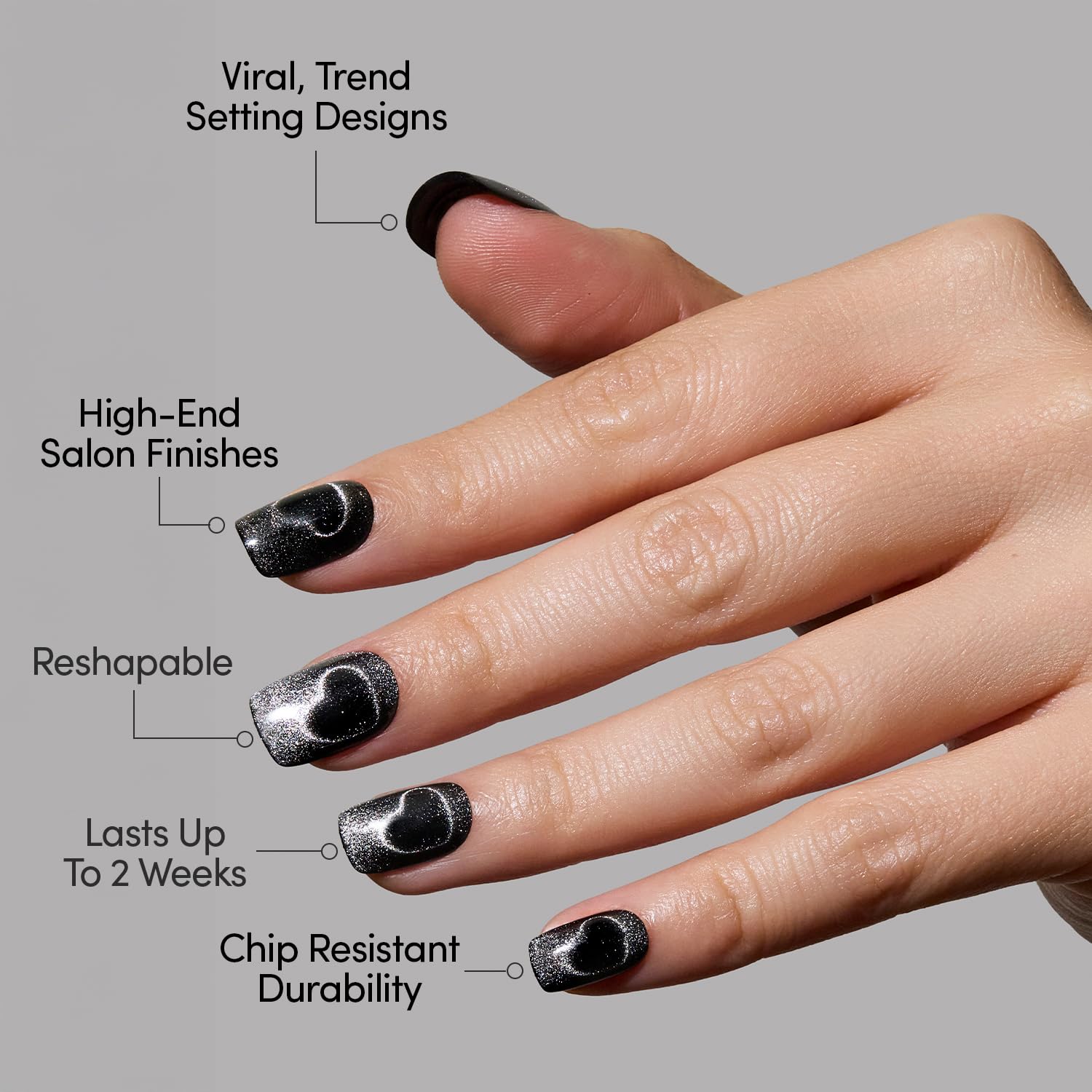 Glamnetic Midnight Romance nails swatch displays moody black finish with silver hearts.