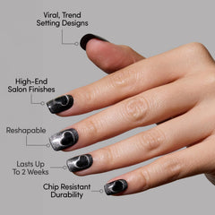 Glamnetic Midnight Romance nails swatch displays moody black finish with silver hearts.