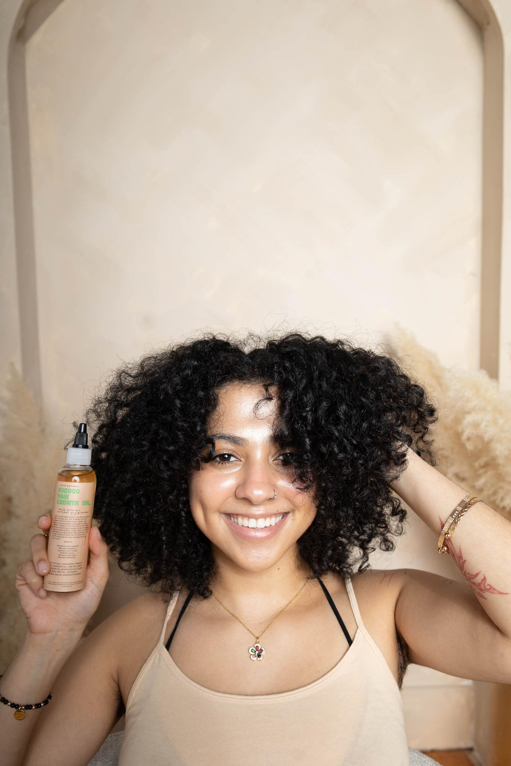 Dropper pour of Glossed by Nae Voodoo Hair Growth Oil shows easy targeted scalp application
