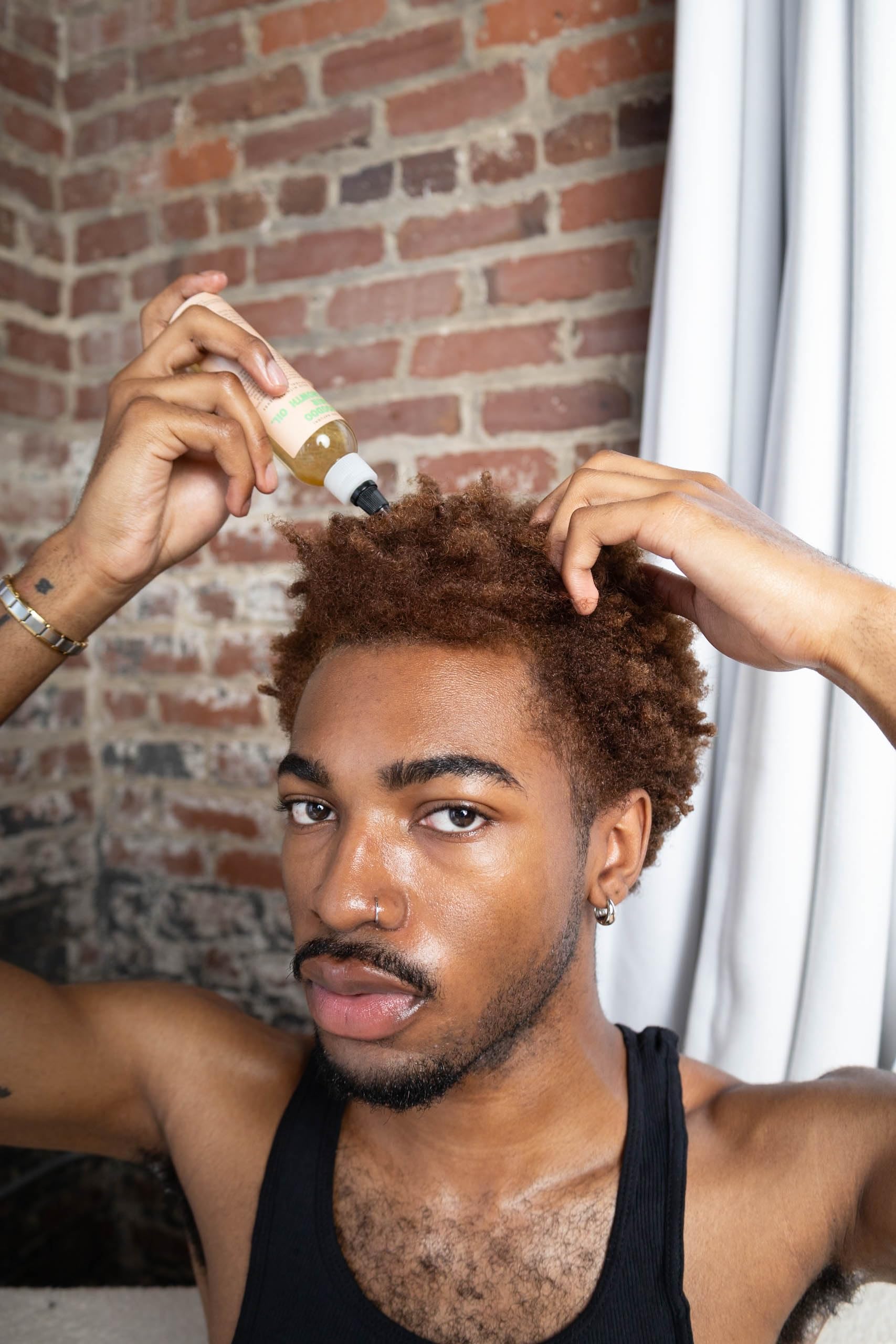 Scalp massage with Glossed by Nae Voodoo Hair Growth Oil suggests soothing nourishment