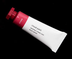Glossier Cloud Paint Storm close-up bottle shows creamy, buildable blush for natural flush.