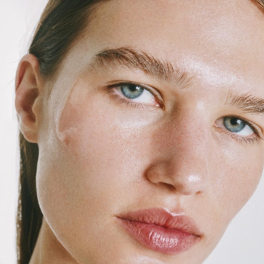 goop Beauty Exosome Hydration Therapy Serum being massaged into cheek demonstrates glow-enhancing hydration