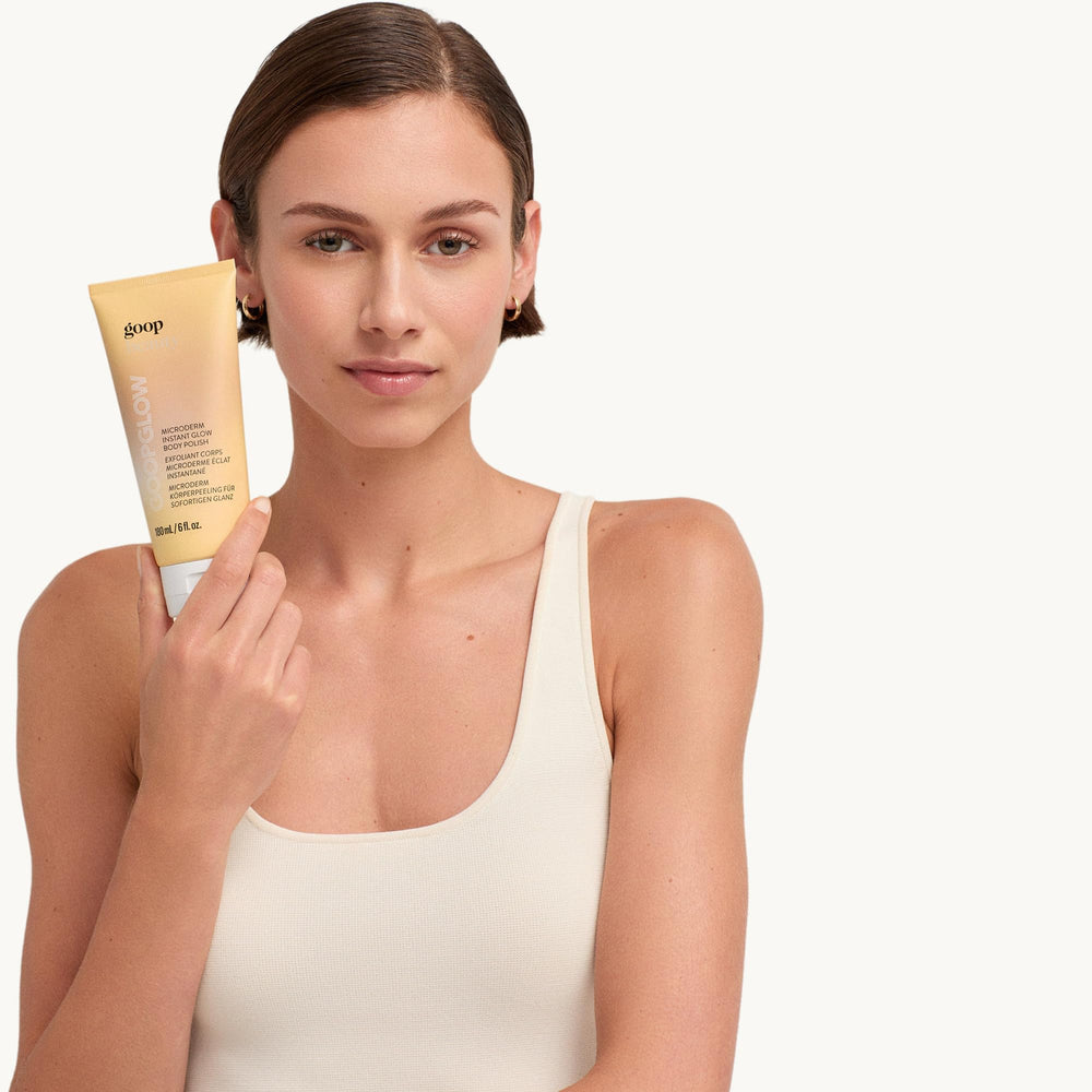 Goop Beauty Microderm Body Polish demonstrates massage application on skin.