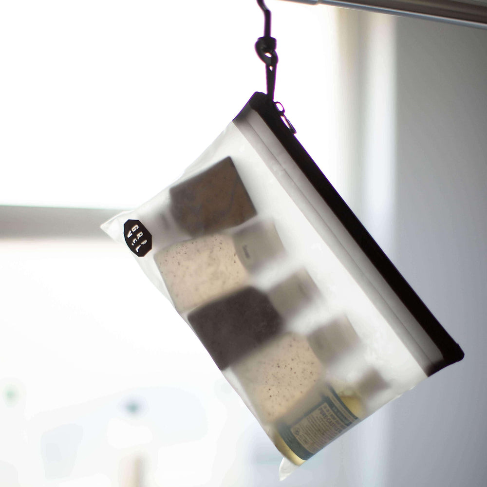 Gravel two-pack shown alongside travel essentials to emphasize TSA-friendly travel kit