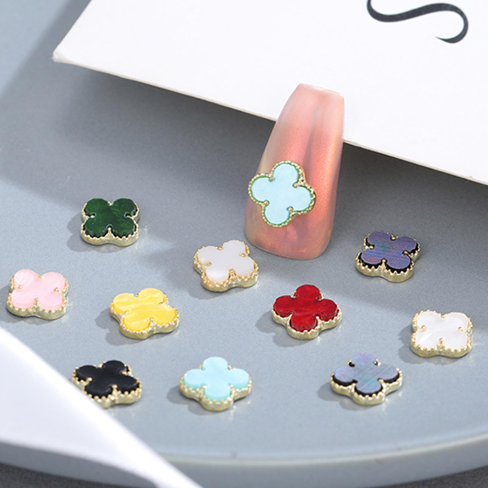 Green Clover nail charms multi-use pack arranged for crafts and nails.