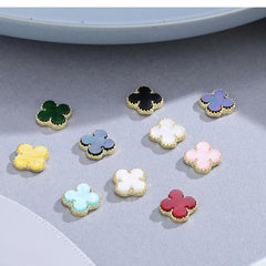 Green Clover nail charms closeup with rhinestone-edge accents for glam nails.