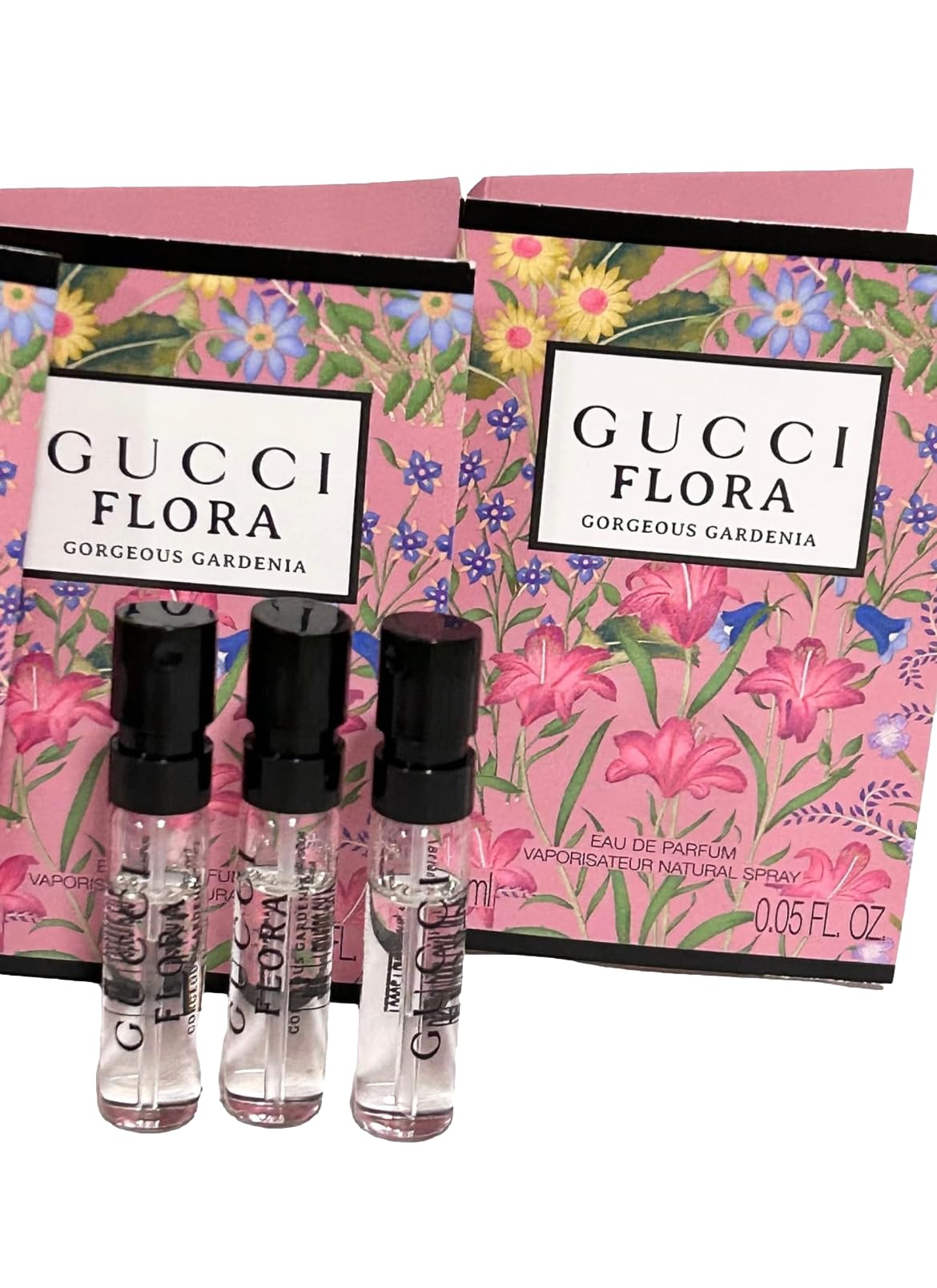 Gucci Flora sample mini bottles arranged for travel or gifting.