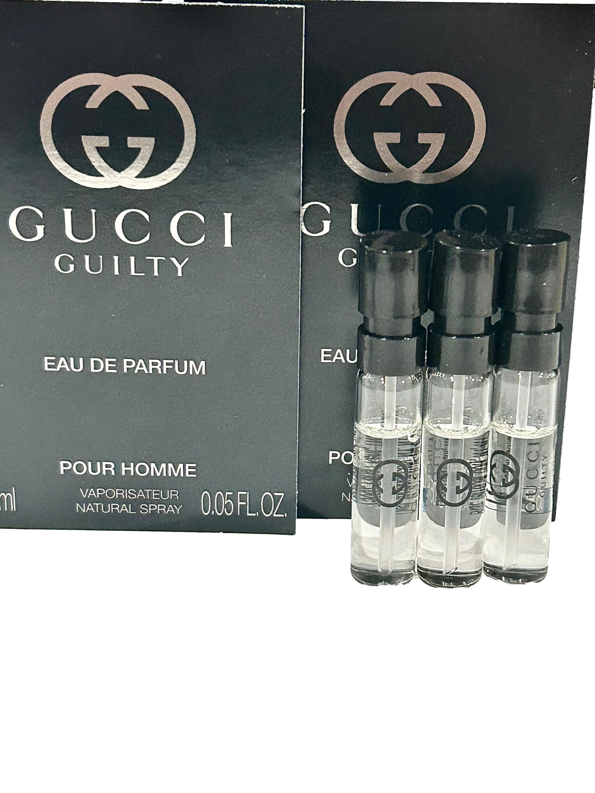 Gucci Guilty parfum 1.5ml bottle close-up, premium parfum spray in a tiny bottle.