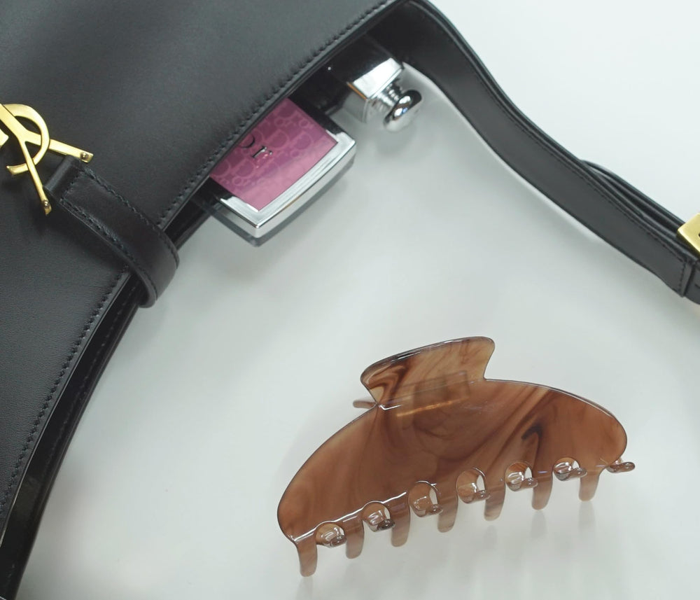 Hana Mia mocha acetate clip dust bag included for gifting or storage.