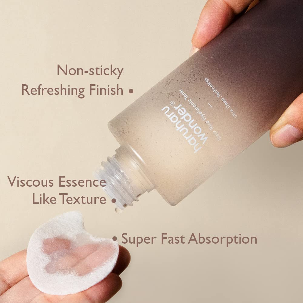 HARUHARU Wonder Black Rice Toner glass bottle held for easy application and control.