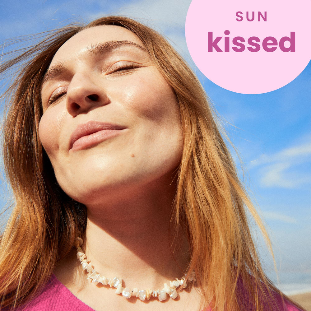 Close-up of Hawaiian Tropic Tropical Lip Balm application shows creamy hydration.