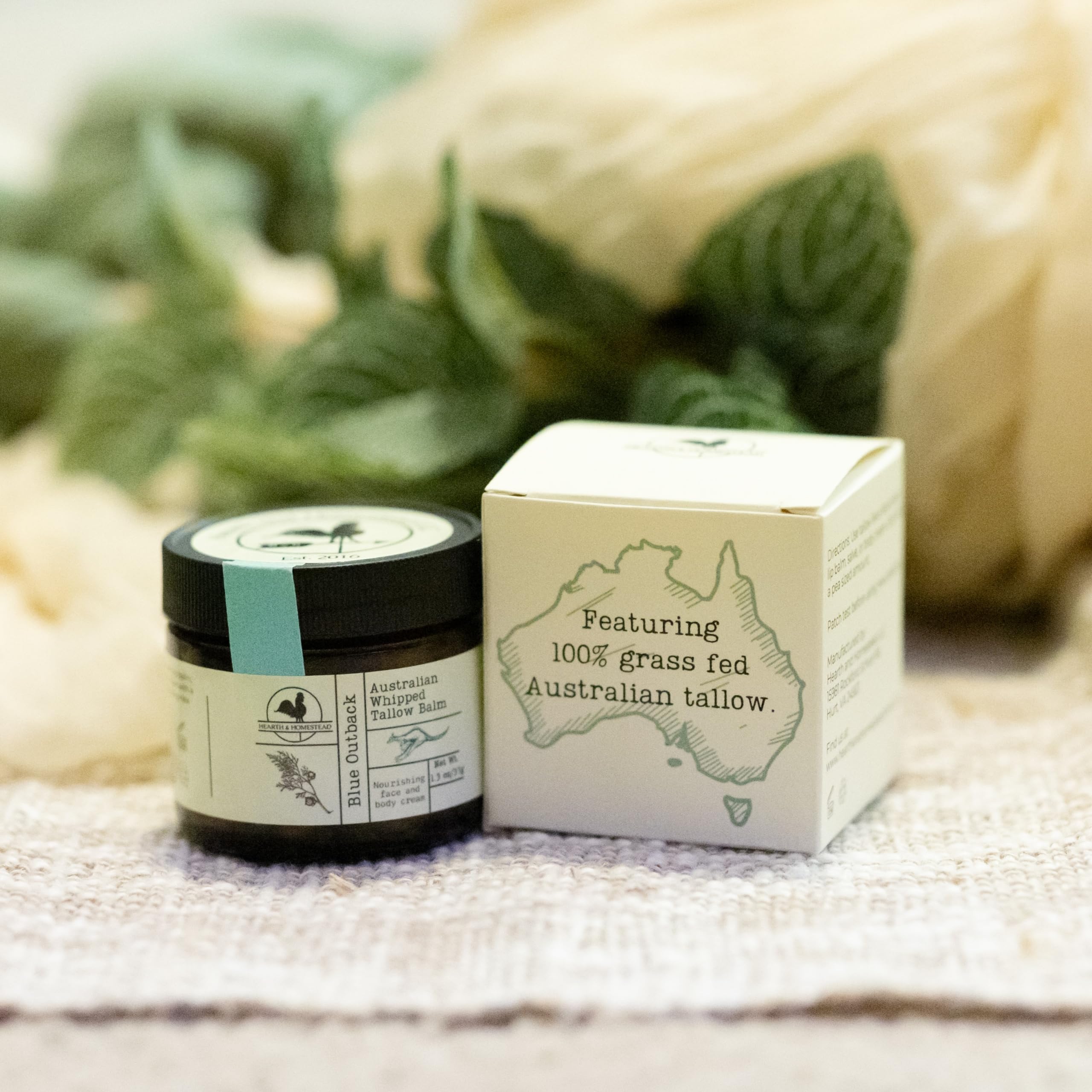 Hearth and Homestead Blue Outback Balm aromatic blend in bottle signals calming, woodsy fragrance.