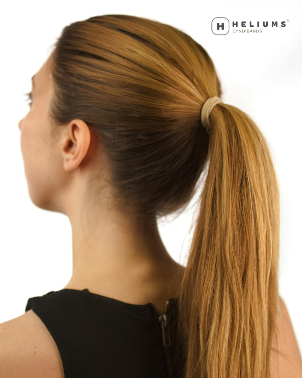 Heliums model wearing brown hair tie demonstrates easy removal and daily styling versatility.