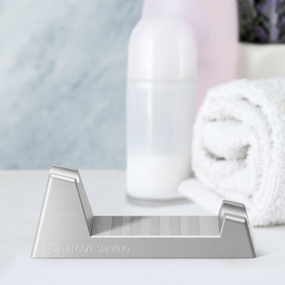 Henson Razor Stand on bathroom counter with razor resting angled for drying