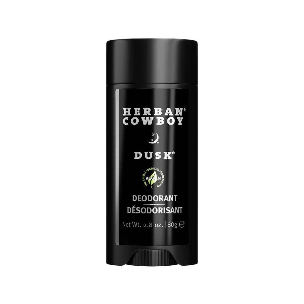 Herban Cowboy Dusk aloe-infused deodorant stick in hand, offering aluminum-free daily freshness.