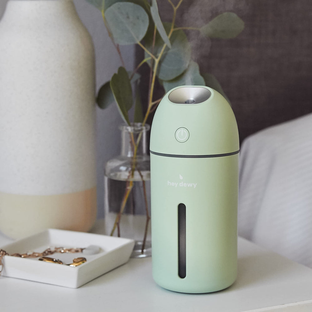 Hey Dewy Sage portable humidifier on a table supports skin hydration routines